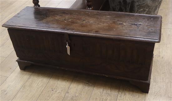 An early 18th century oak coffer, the front carved with vertical flutes and dated 1714 W.114cm